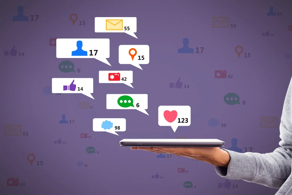 Cross-channel marketing analytics Hand holding tablet with social media icons.