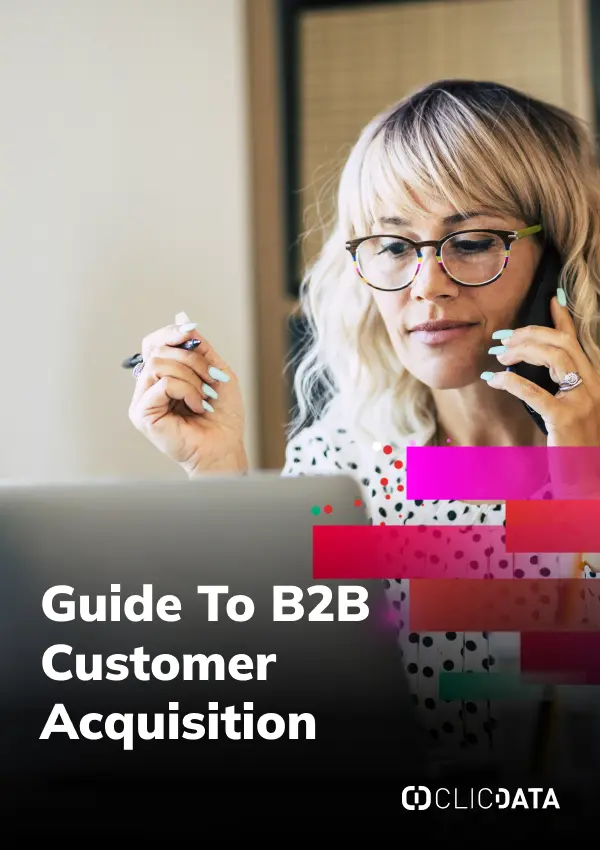 Woman working on laptop, B2B customer acquisition guide.