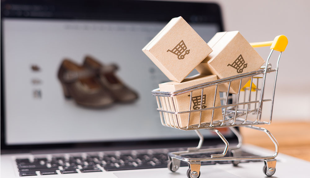 Shopping cart with boxes on laptop screen