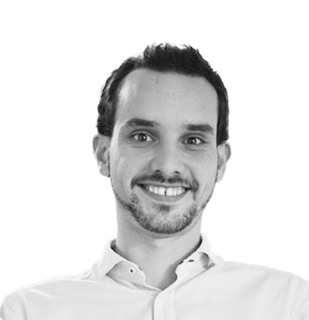 Smiling person in a white shirt, professional portrait.