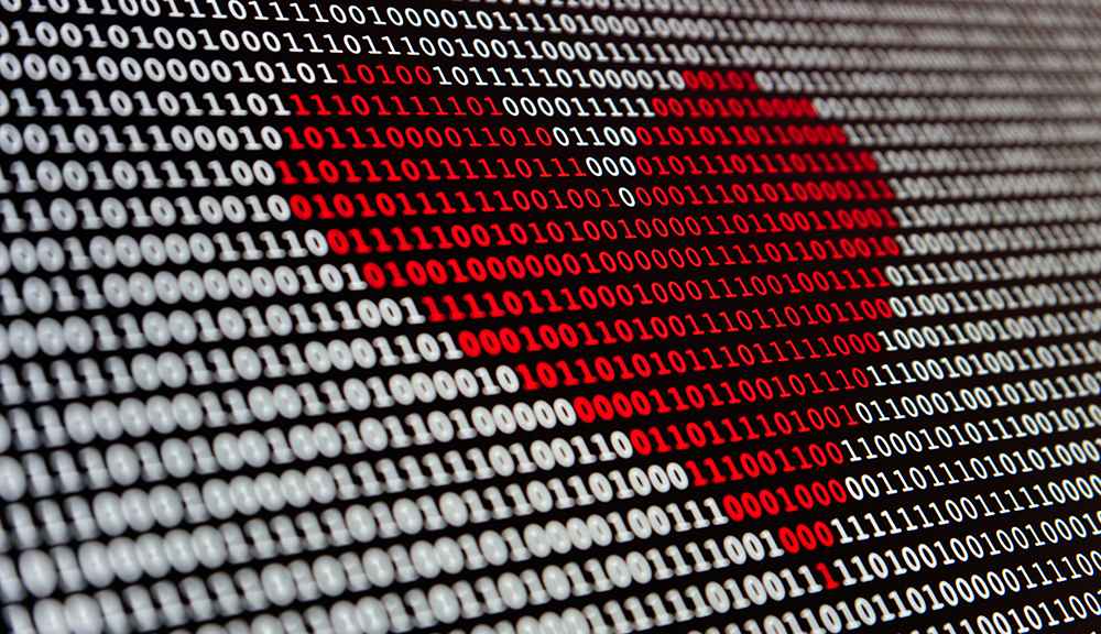 Heart shape made of binary code, ones and zeros.