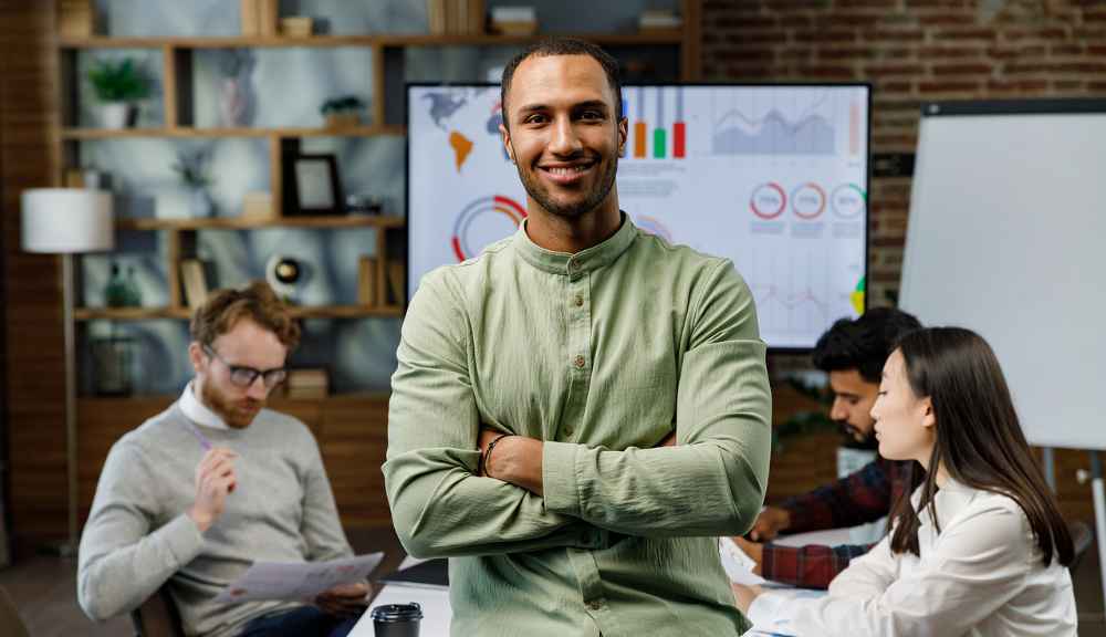 Smiling man in green shirt at business meeting