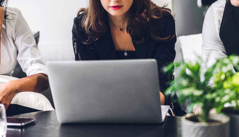 Woman using a laptop at a table