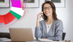 Smiling woman on phone with laptop and colorful chart.