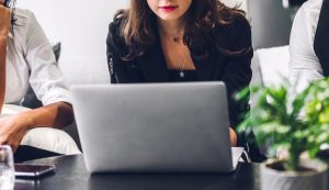 Woman working on laptop in office.