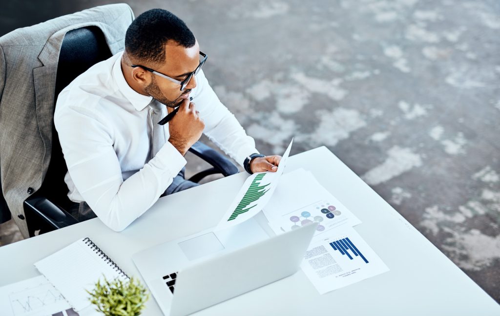 data transformation: Male employee looking at data charts