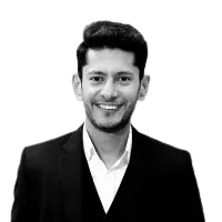 Man in suit smiling against digital background.