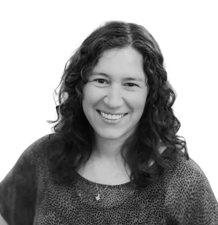 Smiling woman with curly hair, black-and-white portrait