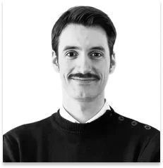 Black-and-white portrait of smiling man with mustache